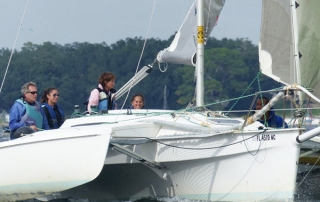 Corsair 36 owner Lee Vogtman controlling the jib sheet on Linda Wrights Corsair 28 center cockpit.