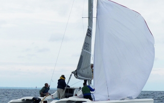 Crew on Wayne's F-24 practicing Randy's method for safely dousing the spinnaker.